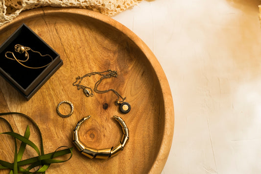 silver rings on brown wooden round tray