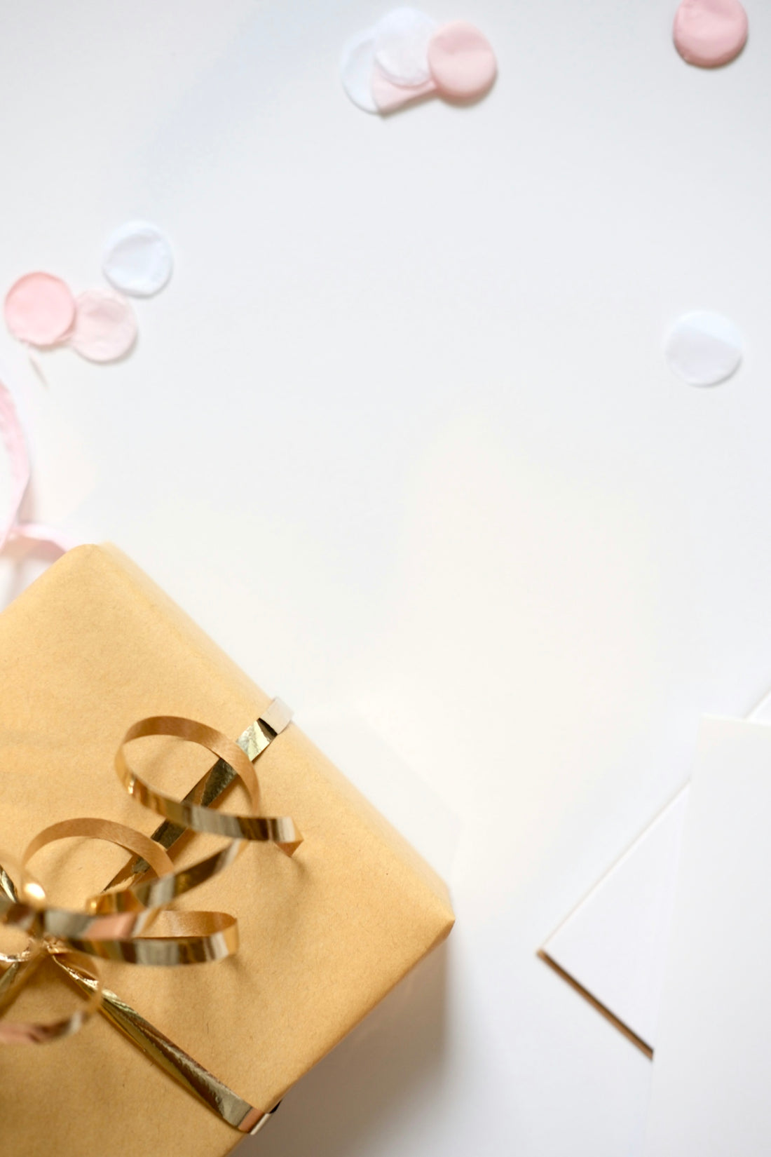 Gift wrapped in gold ribbon with confetti and confetti